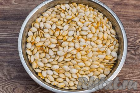 Семечки перебрать, удаляя плоские семечки, не имеющие ядрышек. Промыть хорошие семечки водой, чтобы максимально избавиться от плёночки, которая покрывает их поверхность. Можно мыть семечки, выложив их в миску и залив водой.