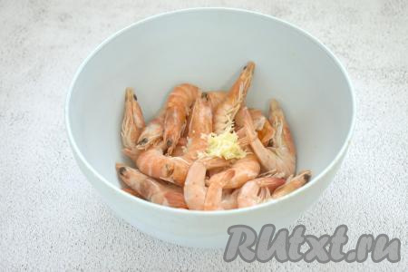 Размороженные креветки помещаем в миску, добавляем пропущенные через пресс (или натёртые на мелкой тёрке) зубчики чеснока.