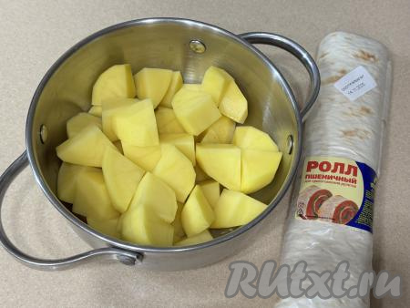 Подготовить продукты для приготовления кыстыбыя с картошкой из лаваша на сковороде. Картошку почистить, нарезать на средние кусочки, выложить в кастрюлю. 