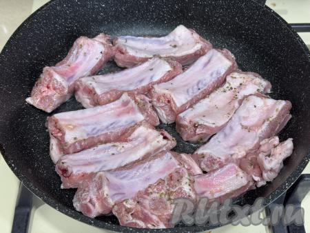 Прогреть в сковороде небольшое количество растительного масла, выложить рёбрышки. 