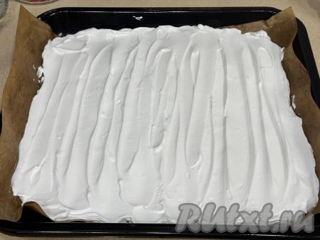 Противень (я взяла небольшой квадратный противень размером 30 сантиметров на 30 сантиметров) застелить пергаментом (или ковриком) для выпечки, выложить меренговую массу, разровнять лопаткой. Я советую использовать силиконизированный пергамент, так как от него безе отделяется достаточно просто. Если вы не уверены в качестве вашего пергамента, тогда предварительно смажьте пергамент тонким слоем растительного масла.