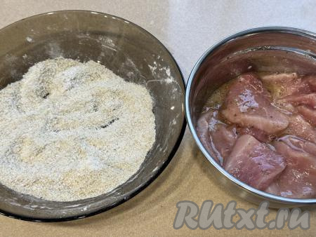 Перемешать кусочки мяса, покрывая их яйцом и специями со всех сторон. В отдельной миске смешать панировочные сухари и крахмал.