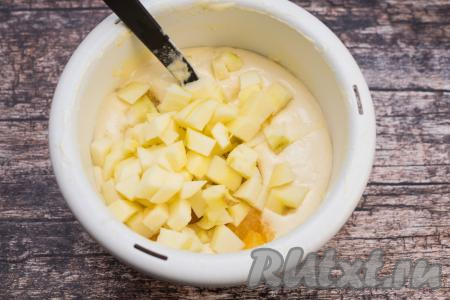 Яблоко очистить от кожуры и семенной коробки с косточками. Нарезать яблоки на небольшие кубики и тоже добавить в миску с тестом.