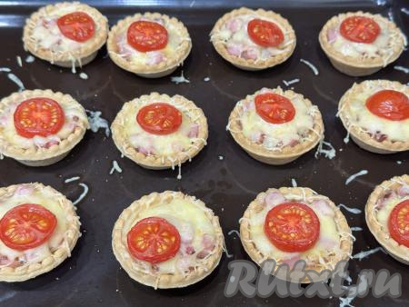 Поставить противень с тарталетками с мини-пиццами в разогретую до 180 градусов духовку, запекать 10-15 минут (до полного расплавления сыра).