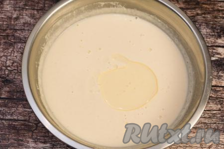 После добавления кипятка тесто для блинов, замешанное на кефире с манкой, будет достаточно жидким. Оставить тесто постоять при комнатной температуре в течение 10 минут, чтобы клейковина муки набухла. Затем влить в блинное тесто 2 столовых ложки растительного масла, хорошо перемешать. Благодаря маслу в составе теста, блины будут лучше переворачиваться в процессе жарки на сковороде.