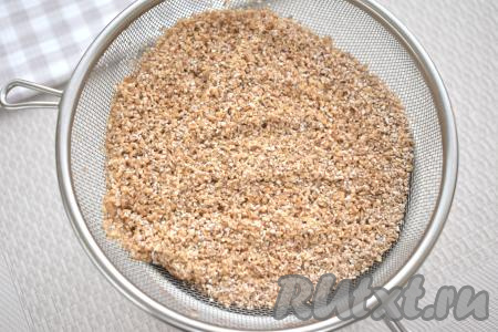 Пшеничную крупу выкладываем в сито с мелкими ячейками, промываем под проточной водой. Оставляем на время, пока будем обжаривать овощи с фаршем, чтобы с крупы стекла вода.
