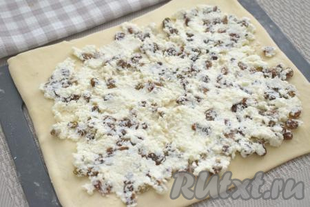 На раскатанное тесто, обступая от краёв по 1 сантиметру, равномерно распределяем творожную начинку.