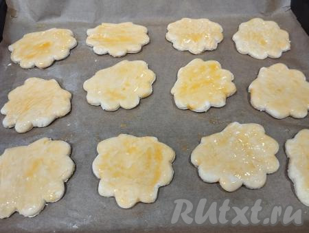 Яичный желток в небольшой ёмкости взбиваем вилкой до однородности. При помощи кулинарной кисточки смазываем ракушки из слоёного теста взбитым желтком.