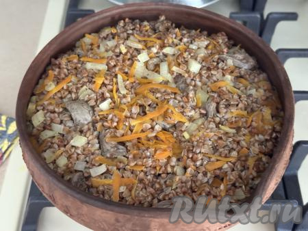 Форму с гречкой и куриными сердечками накрыть фольгой и поставить в разогретую до 180 градусов духовку на 1 час.&nbsp;