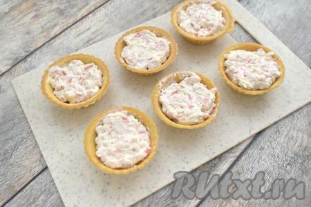 Заполняем песочные тарталетки получившейся начинкой из крабовых палочек и творожного сыра.