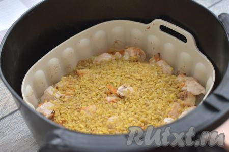 После звукового сигнала достаём чашу с мясом и овощами из аэрогриля. Перемешиваем мясо курицы с морковкой и луком, сверху выкладываем булгур.