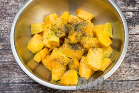 Выложить нарезанные кусочки тыквы в глубокую миску, влить растительное масло, посолить, добавить любимые специи. Перемешать, покрывая тыкву маслом и специями со всех сторон.