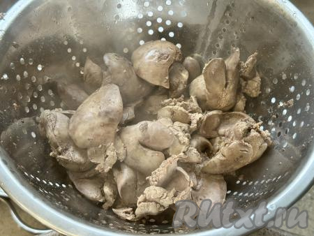 Откинуть сварившуюся печёнку на дуршлаг, дать стечь воде. Слегка остудить печень.