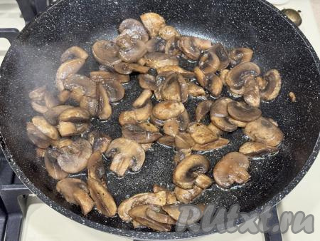 В качестве начинки для этих рулетиков я использовала шампиньоны, но можно взять и вешенки, лесные грибы. Лесные грибы нужно будет заранее отварить в течение 25-30 минут с момента закипания воды, после этого откинуть на дуршлаг, дать лишней воде стечь. Шампиньоны, вешенки предварительно отваривать не нужно, их просто нужно промыть водой и немного обсушить. Подготовленные грибы нарезать на части, выложить на сковороду, уже хорошо разогревшуюся с растительным маслом, обжарить грибы до готовности (в течение 12-15 минут), периодически перемешивая, на среднем огне. В конце обжаривания грибы нужно будет подсолить. Жареные грибы убрать с огня, дать остыть.