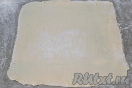Сливочное масло растопить до жидкого состояния, дать ему немного остыть.&nbsp;Слоёное тесто у меня было в двух пластах. Вначале один пласт размороженного слоёного теста выложить на рабочую поверхность, присыпанную мукой, и раскатать в прямоугольник толщиной примерно 2 миллиметра.