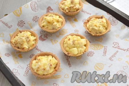 Противень с тарталетками с курицей, ананасами и сыром отправляем&nbsp;в духовку, заранее разогретую до 180 градусов, запекаем 8-10 минут (до появления на поверхности аппетитной корочки).