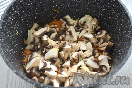 Пока обжариваются овощи, моем шампиньоны, нарезаем их на небольшие кусочки. После того как морковка станет достаточно мягкой, добавляем к обжаренным овощам нарезанные грибы, перемешиваем, обжариваем 6-7 минут, иногда помешивая.