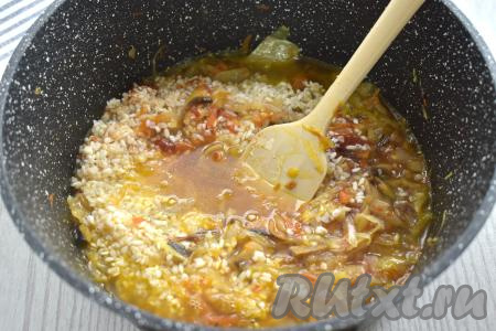 Вливаем 230 миллилитров кипящей воды, перемешиваем рис с капустой и грибами. Ещё раз даём воде закипеть.