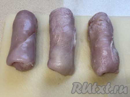 Начиная с края мяса, расположенного ближе к маслу, свернуть филе в рулет, запечатывая масло внутри. В результате у нас получатся 3 заготовки котлет по-киевски. Старайтесь хорошо завернуть масло в мясо, иначе масло вытечет при запекании в аэрогриле.
