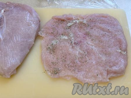 Накрыть филе пищевой плёнкой и аккуратно отбить с помощью кулинарного молоточка, стараясь сохранить целостность всей отбивной. Посолить&nbsp;куриные отбивные с двух сторон и приправить специями.