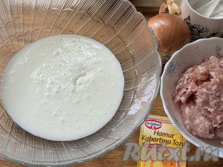 Прежде всего замесим бездрожжевое тесто для пирожков с мясом. Желательно, чтобы кефир был комнатной температуры. Кефир можно заранее достать из холодильника, чтобы он постоял при комнатной температуре и согрелся. А можно налить кефир в чашку, подогреть его в микроволновке на максимальной мощности в течение 30 секунд. Кефир комнатной температуры влить в достаточно объёмную миску, в которой будете замешивать тесто, всыпать соду, хорошо перемешать столовой ложкой и оставить минут на 5. За это время сода полностью погасится в кефире, поэтому на поверхности кефира появятся пузырьки.&nbsp;&nbsp;