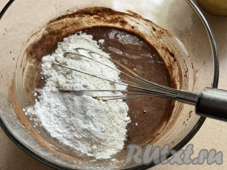 Перемешать шоколадную массу до однородности венчиком. Всыпать весь разрыхлитель и 50 грамм муки, перемешать тесто венчиком.