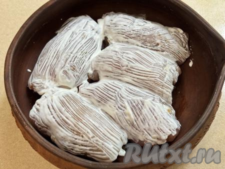 Сверху каждый рулетик смазать сметаной. Поставить форму в духовку, разогретую до 180 градусов, запекать куриные рулетики с грибами 40 минут. Если сомневаетесь в готовности, тогда разрежьте один куриный рулетик, если мясо светлое, без розового оттенка, значит блюдо готово.