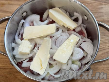 Поверх лука разложить сливочное масло, нарезанное на кусочки. Влить в кастрюлю 100 миллилитров воды.&nbsp;