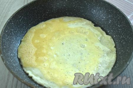 Для приготовления этого блюда желательно брать сковороду, диаметр которой будет чуть больше или равен диаметру тортильи, которую вы используете. Я купила тортилью диаметром 20 сантиметров, поэтому и готовила на сковороде диаметром 20 сантиметров. Но если вы купите тортилью достаточно большого диаметра, а подходящей сковороды у вас нет, тогда с помощью кулинарных ножниц можно обрезать тортилью по кругу до нужного диаметра. Разогреваем на сковороде растительное масло. На горячую сковороду выливаем яичную массу. Даём яичной массе на среднем огне полностью "схватиться" (на поверхности яичной массы не должно быть влажных участков, на это потребуется 1-2 минуты).
