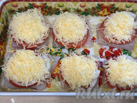 Поверх каждого кусочка филе минтая пышной шапкой выложить сыр, натёртый на крупной тёрке.&nbsp;