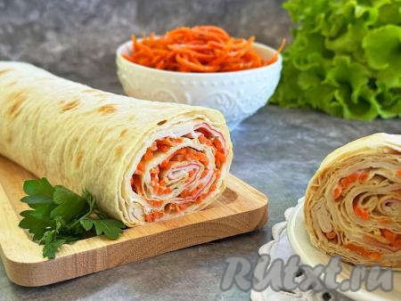 Аппетитный, вкусный рулет из лаваша с нежной, пикантной начинкой из крабовых палочек и корейской моркови выложить на тарелку и подать к повседневному или к праздничному столу.