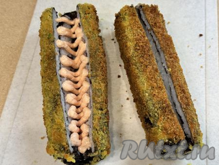 Отсадить внутрь каждой заготовки соус из творожного сыра и икры. Если нет кулинарного мешка, то просто аккуратно разложите соус в разрезы хот-догов.
