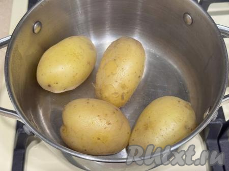 После закипания воды сразу уменьшить огонь до минимума и варить молодую картошку до готовности (ориентировочно в течение минут 20, готовый картофель будет легко прокалываться зубочисткой). Затем убрать кастрюлю с огня, воду, в которой варилась картошка, вылить. Дать картошинам немного остыть.