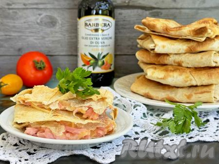 Аппетитные конвертики из лаваша с сыром и колбасой подать к столу в горячем виде, пока сыр приятно тянется.