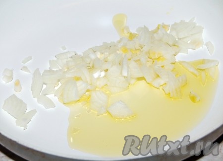 Разогреть растительное масло на сковороде, добавить мелко нарезанный репчатый лук.