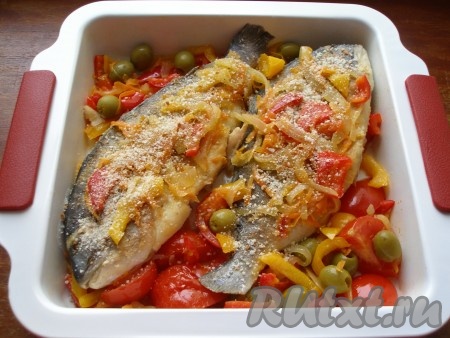 Присыпать рыбу панировочными сухарями. Отправить дораду с овощами запекаться в разогретую до 190 градусов духовку на 20-25 минут.
