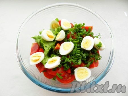 Перепелиные яйца разрезать пополам и выложить в салат из помидоров черри и зелени.
