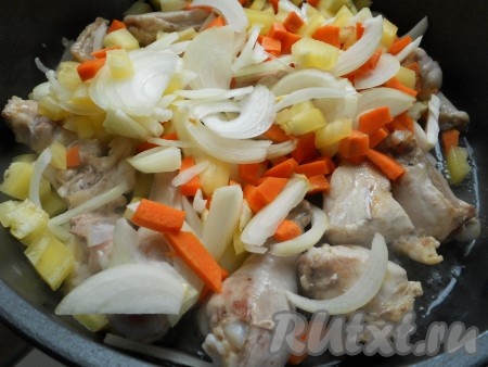 Выложить курицу в сотейник с разогретым растительным маслом. Немного обжарить и добавить лук, морковь и перец.