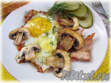 Подавайте яичницу с помидорами, ветчиной, грибами и сыром сразу же. Приятного аппетита!
