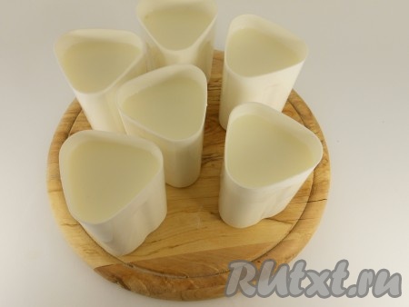 Перелить молоко с закваской в стаканчики для йогурта (если их нет, можно использовать небольшие стеклянные баночки). 