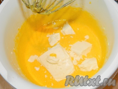 В отдельной посуде растираем миксером желтки с сахаром до бела. В смесь желтков и сахара, перемешивая миксером, добавляем растопленное до жидкого состояния не горячее сливочное масло.