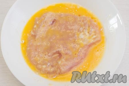 Обмакнуть мясо с двух сторон во взбитые яйца. Подготовить таким образом столько отбивных, сколько одновременно могут поместиться на сковороде.
