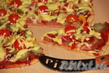 Поставить пиццу в разогретую духовку и выпекать при температуре 180 градусов, примерно, 15-20 минут. Очень вкусную, аппетитную пиццу, приготовленную на тонком бездрожжевом тесте, можно подавать к столу.