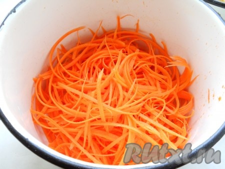 Морковь натереть на терке для корейской моркови, поместить в кастрюлю. Влить кипящую воду, чтобы она покрыла морковь, через 2-3 минуты откинуть морковь на дуршлаг и промыть холодной водой.
