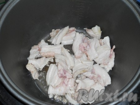 В чашу мультиварки влить масло и выложить мясо. Выставить режим "Жарка" на 15 минут.
