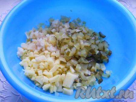 Огурцы маринованные порезать также небольшими кубиками и добавить к рыбе и картофелю.
