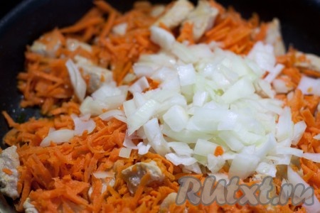 Затем добавьте в сковороду натертую на крупной терке морковь и мелко рубленный лук. Уменьшите температуру нагрева и потушите овощи с мясом некоторое время.
