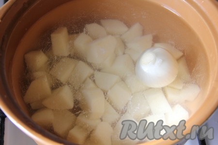 В кастрюлю добавить воду, порезанный картофель и 1 целую луковицу. Поставить на огонь и варить до полуготовности картофеля.
