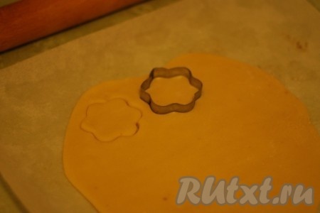 Раскатать песочное тесто толщиной 0,5 см, вырезать формочкой печенье.
