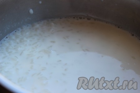 В другую кастрюлю влить молоко и дать ему закипеть. Всыпать рис в молоко, тщательно размешать. Варить рисовую кашу на медленном огне в течение 15-20 минут, не забывая часто помешивать.
